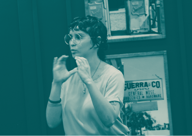 Photo of a person signing “communicate” in half-tone hues of mint, yellow, purple, and pink.